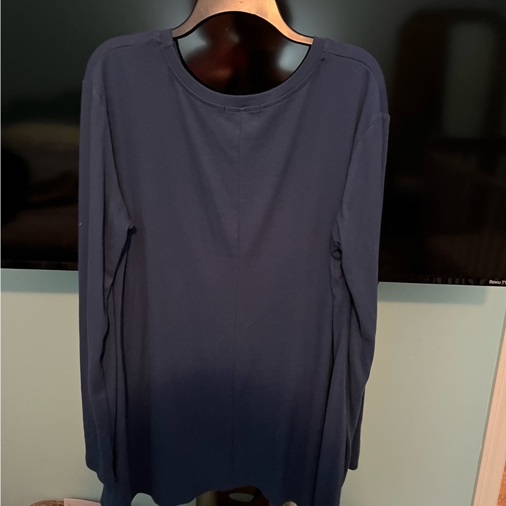 Long shirt with lace on bottom in front. Works well with leggings or jeans